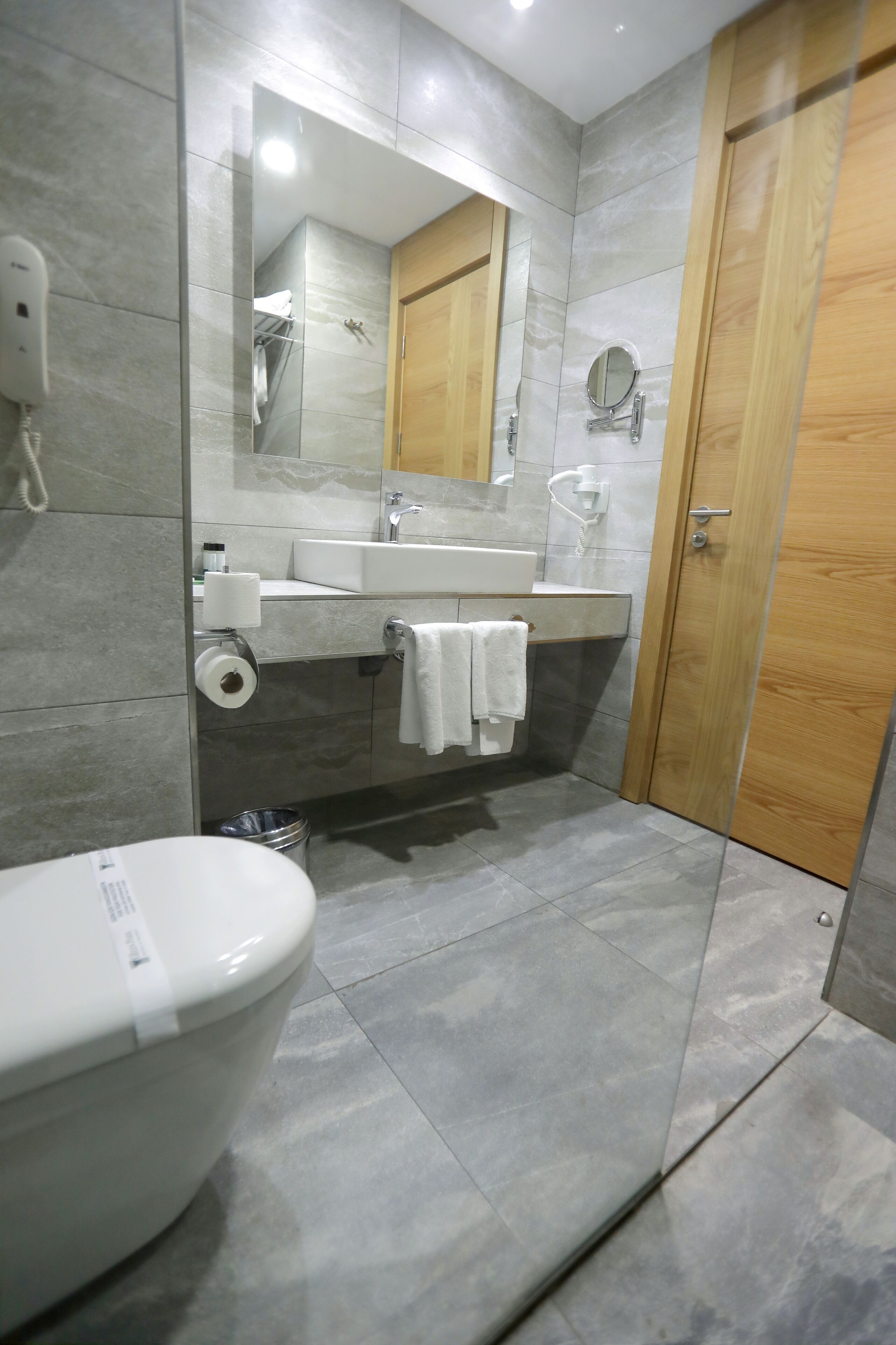 designer toiletries, hair dryer, slippers, towels