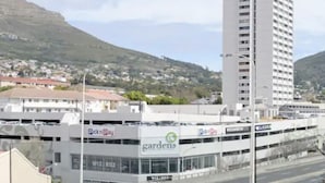 A view from a high-rise building overlooking a cityscape with a prominent mountain in the background. - Lily By Stay Amazing (Cape Town)