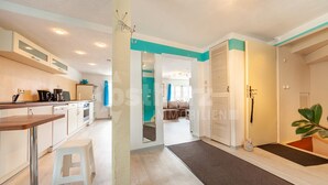 Un appartement moderne comprenant une cuisine, un espace de vie et un escalier menant à une mezzanine.