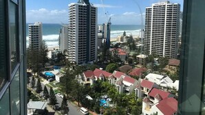 A high-rise hotel with multiple floors, a pool, and a view of the ocean. - Private Apartments at Q1 (Surfers Paradise)