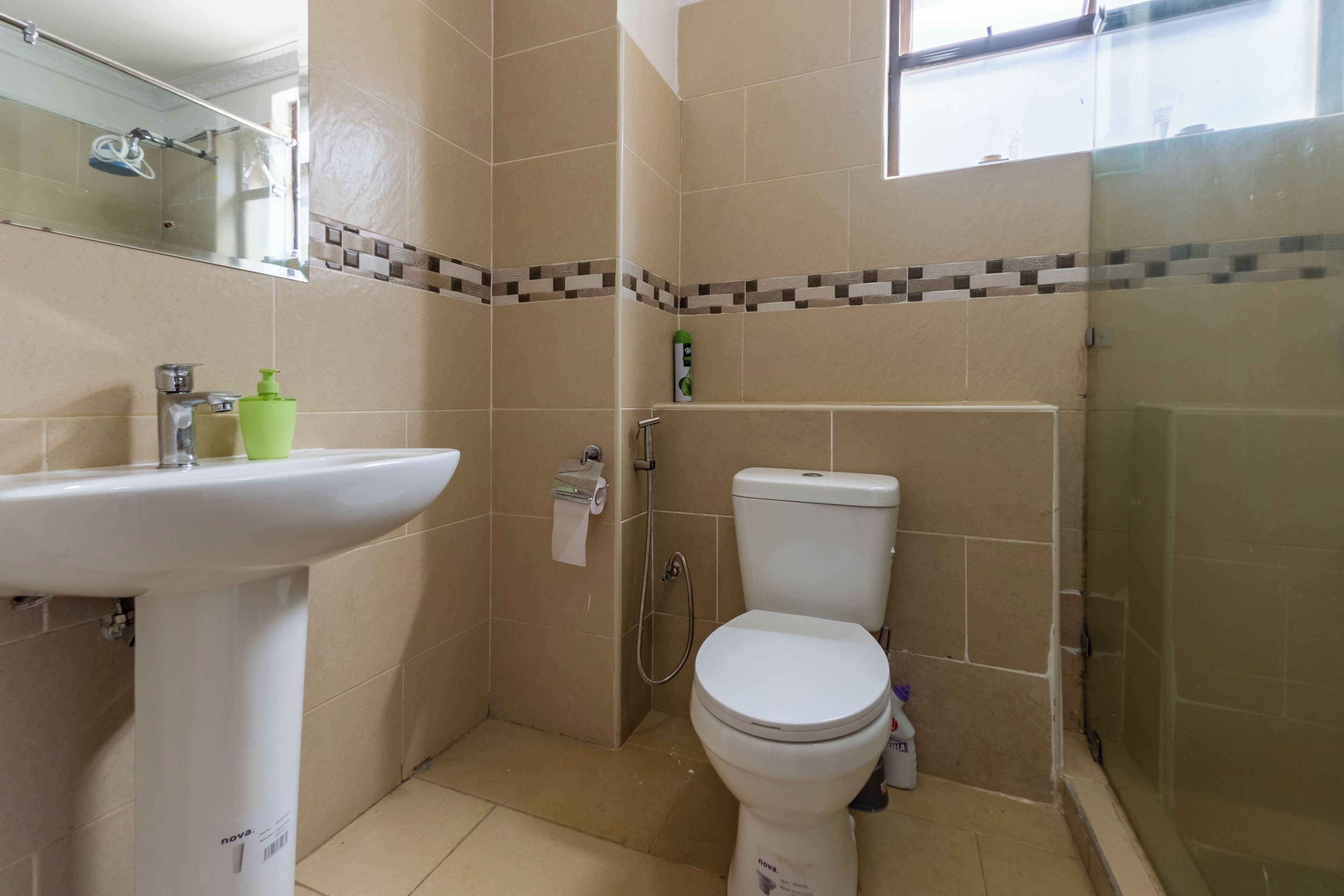 A bathroom with a white sink, toilet, and shower.