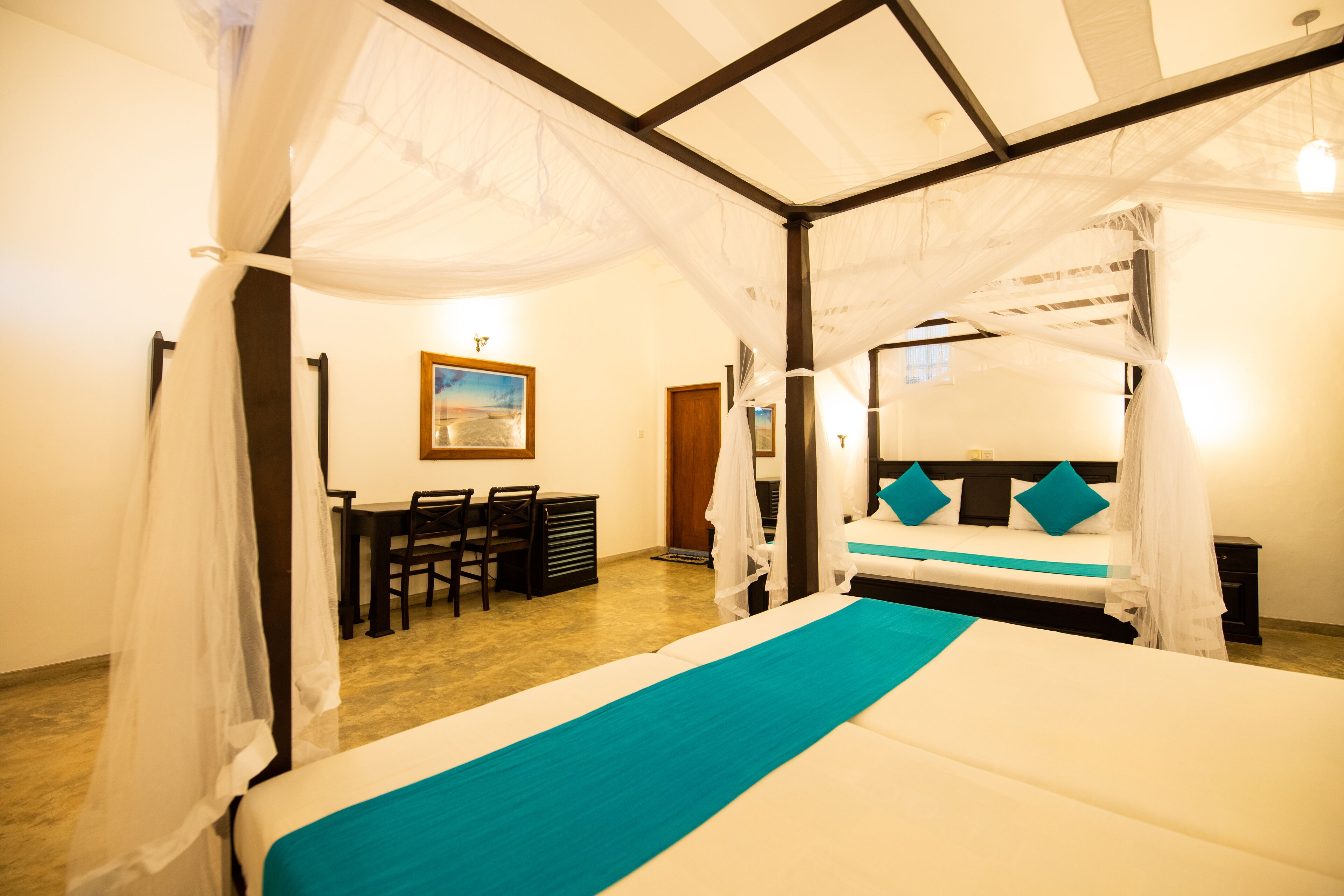 A bedroom with a bed, a desk, and a chair.