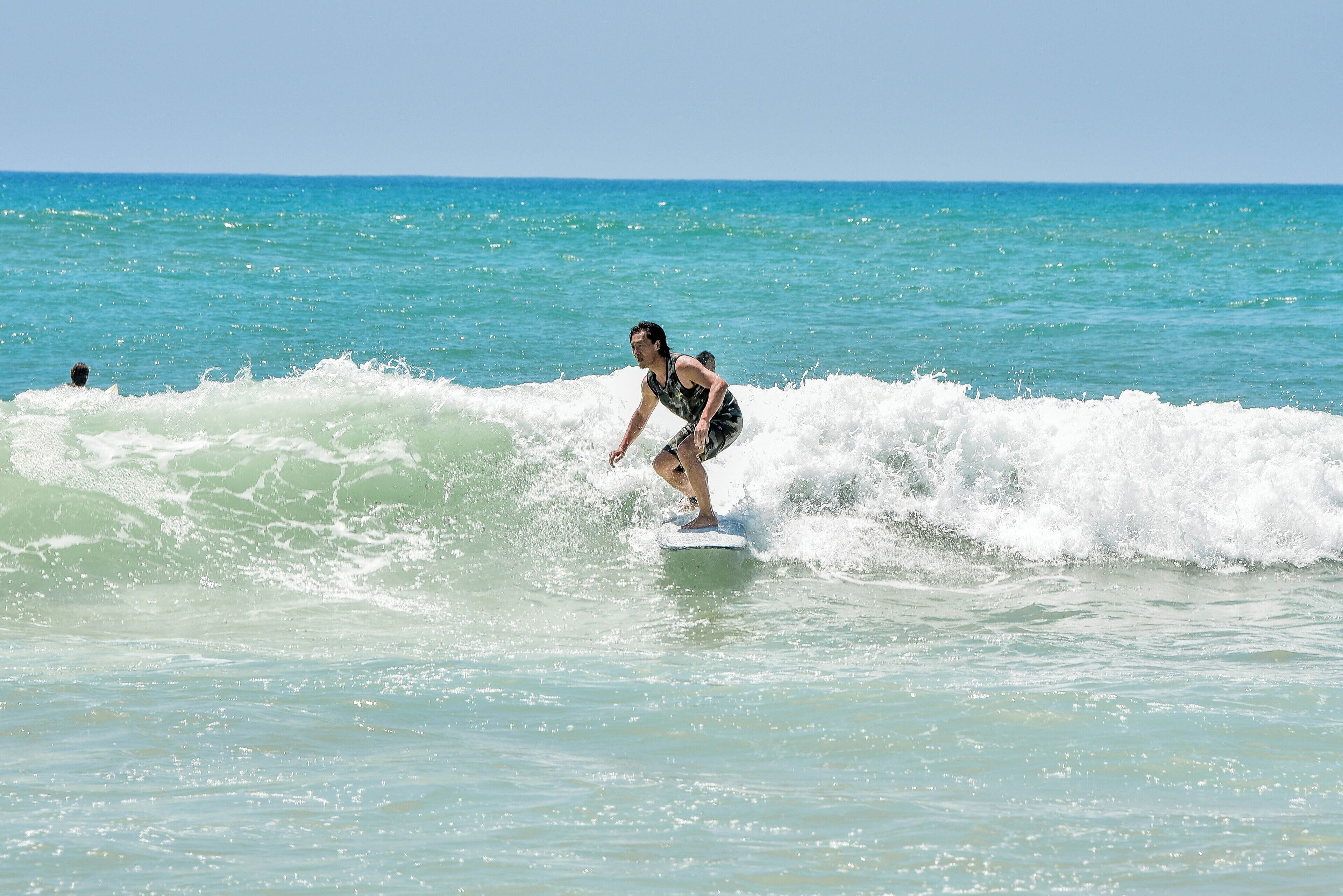 A person surfing on a wave in the ocean.