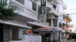A multi-story building with balconies, a sign for 'Hotel Shanti', and a motorcycle parked in front. - Hotel Shanti (Gaya)