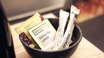 A black bowl containing various tea packets.