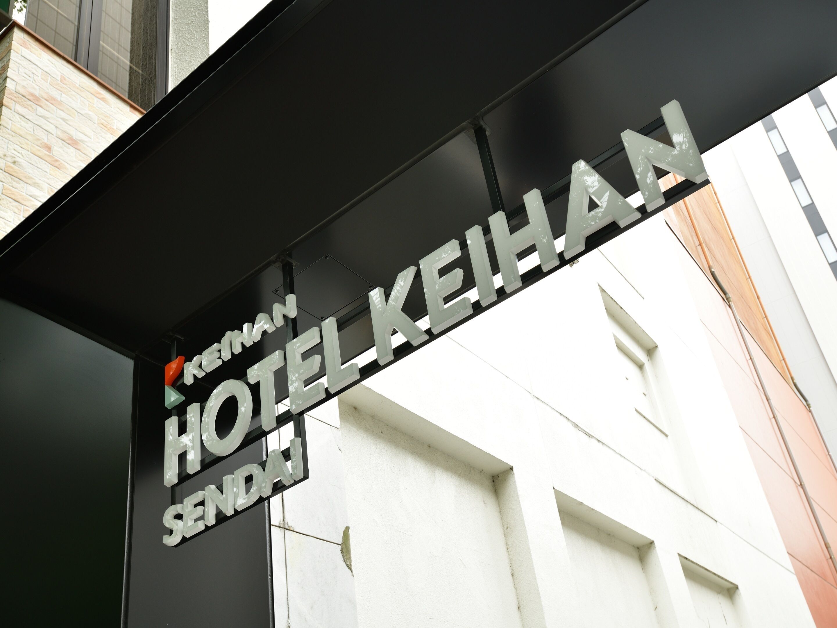 A hotel sign with the name "Kerman Hotel Sendai".