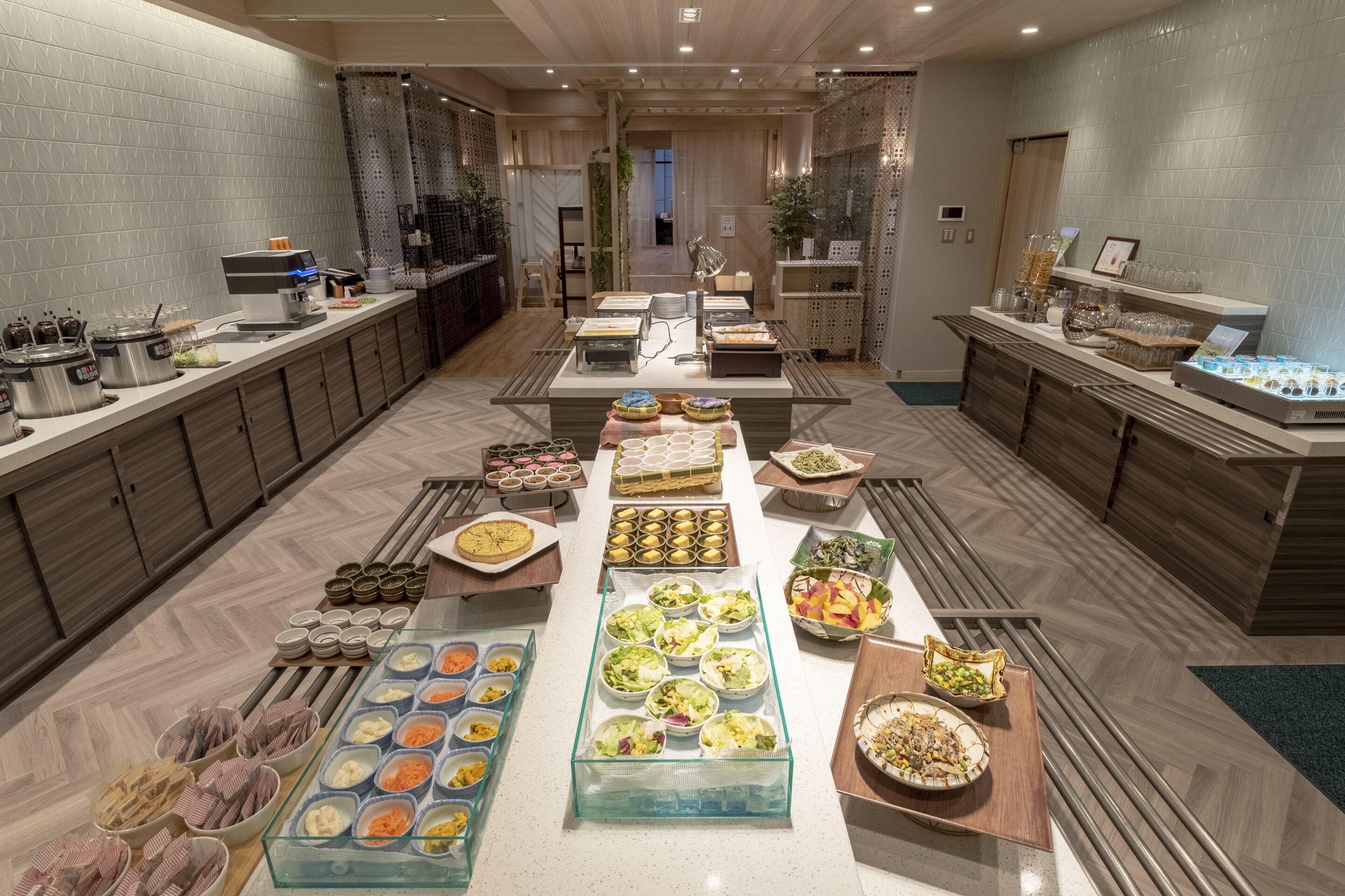 A buffet setup with various food items and a coffee station.