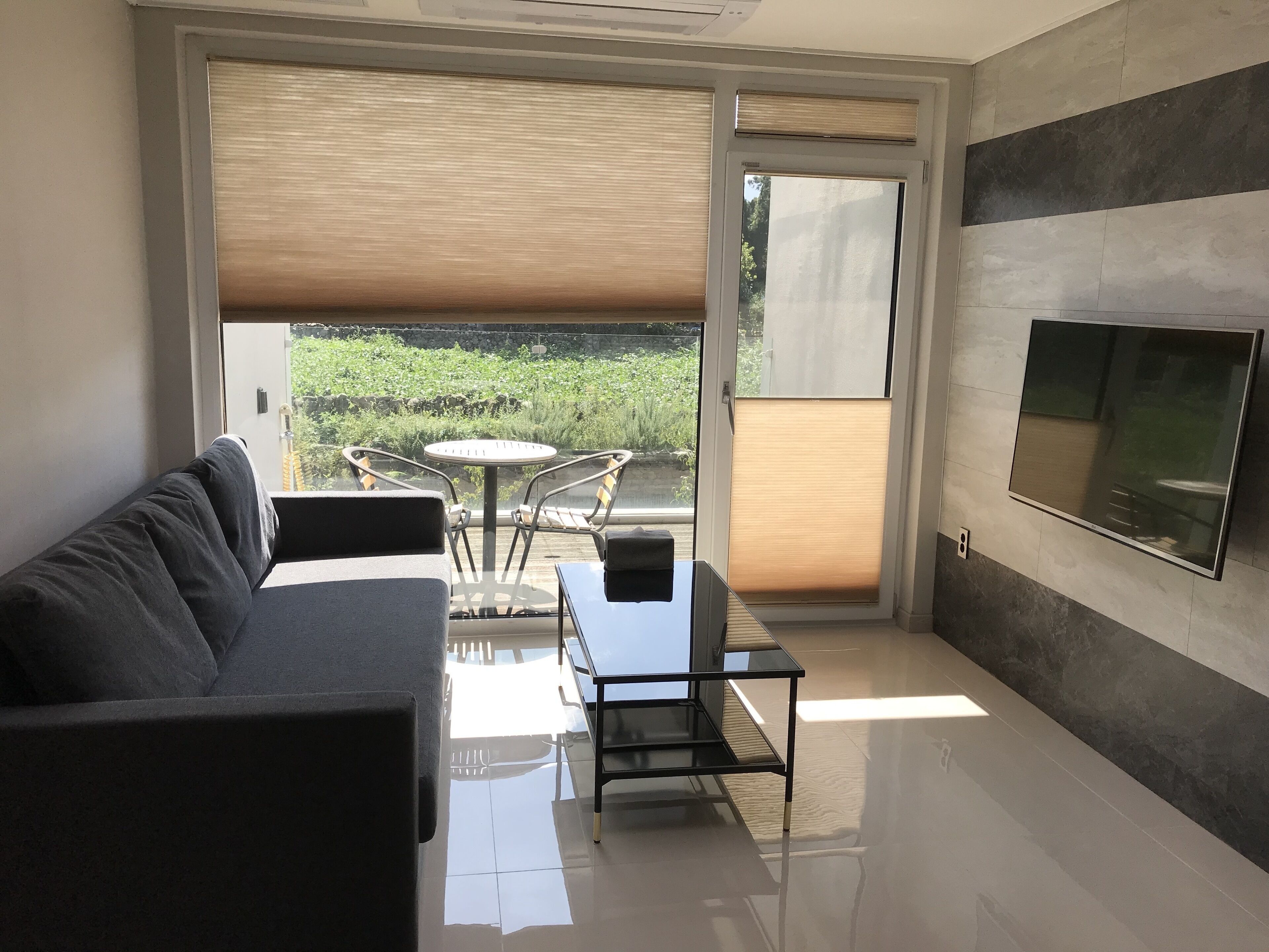 Terraced resort pension with deck & mountain view | Living area | 50-inch LED TV with cable channels, TV, toys