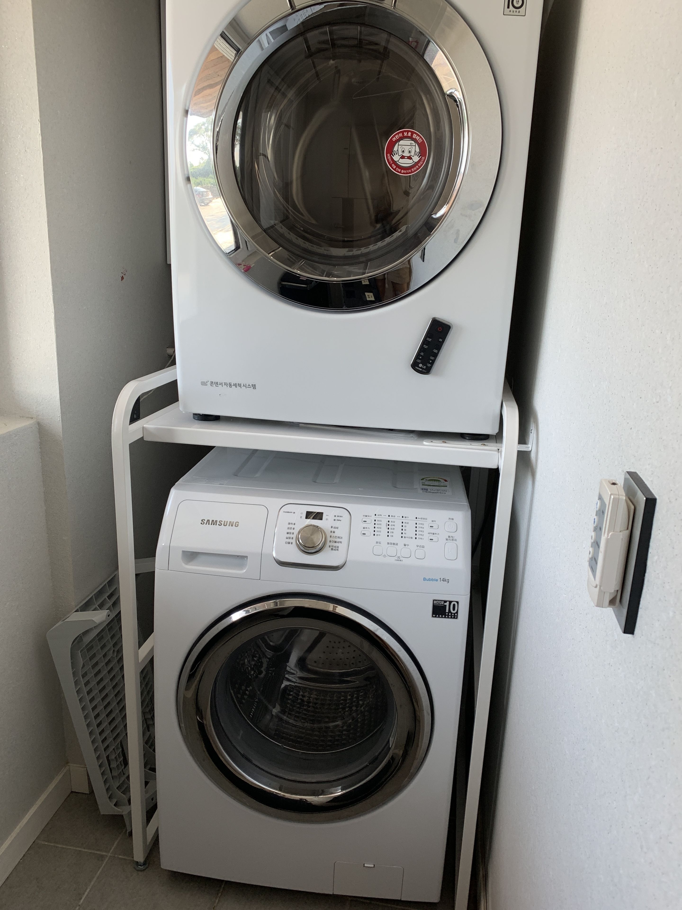 A stacked washer and dryer unit with a control panel and a digital display.
