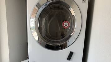 A stacked washer and dryer unit with a control panel and a digital display.