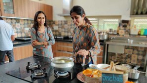 A kitchen with a gas stove, a pot on the stove, and a sign that reads "Sneha's Kitchen". - Vatsalya Vihar - A Luxury Pool Villas Resort (Udaipur)