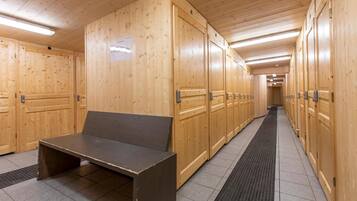 A row of wooden lockers with a bench in the center.