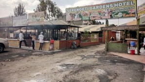 A roadside eatery with a signboard advertising ready pork, goat meat, and other local dishes. - Serengeti Gardens Hotel (Nairobi)