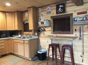 Enjoy cooking in this cabin-style kitchen with microwave, sink, and central island.