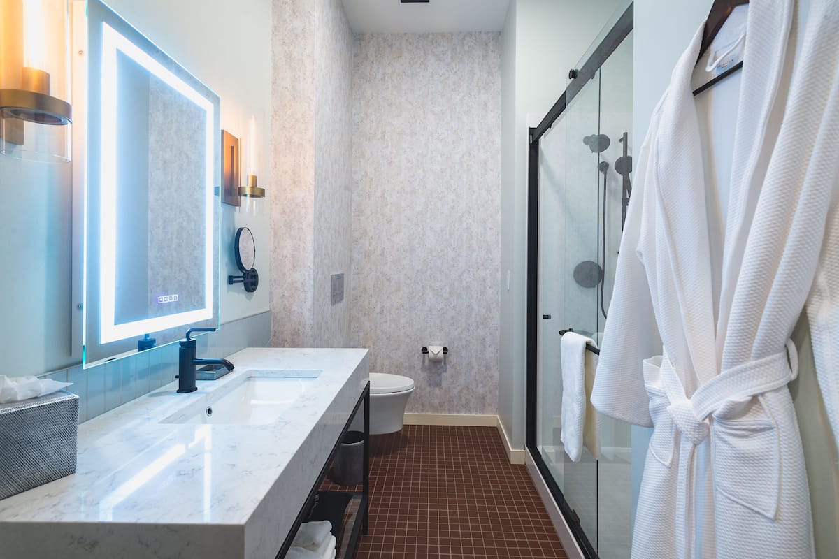signature room | bathroom | shower, rainfall showerhead, designer toiletries, hair dryer