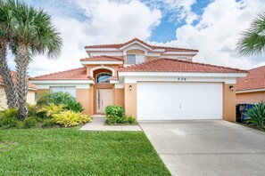 A two-story house with a red-tiled roof, a garage, and a well-maintained lawn. - Private Pool Home With Fantastic Upgrades. Very Safe for Children! - 5av534 (Davenport)