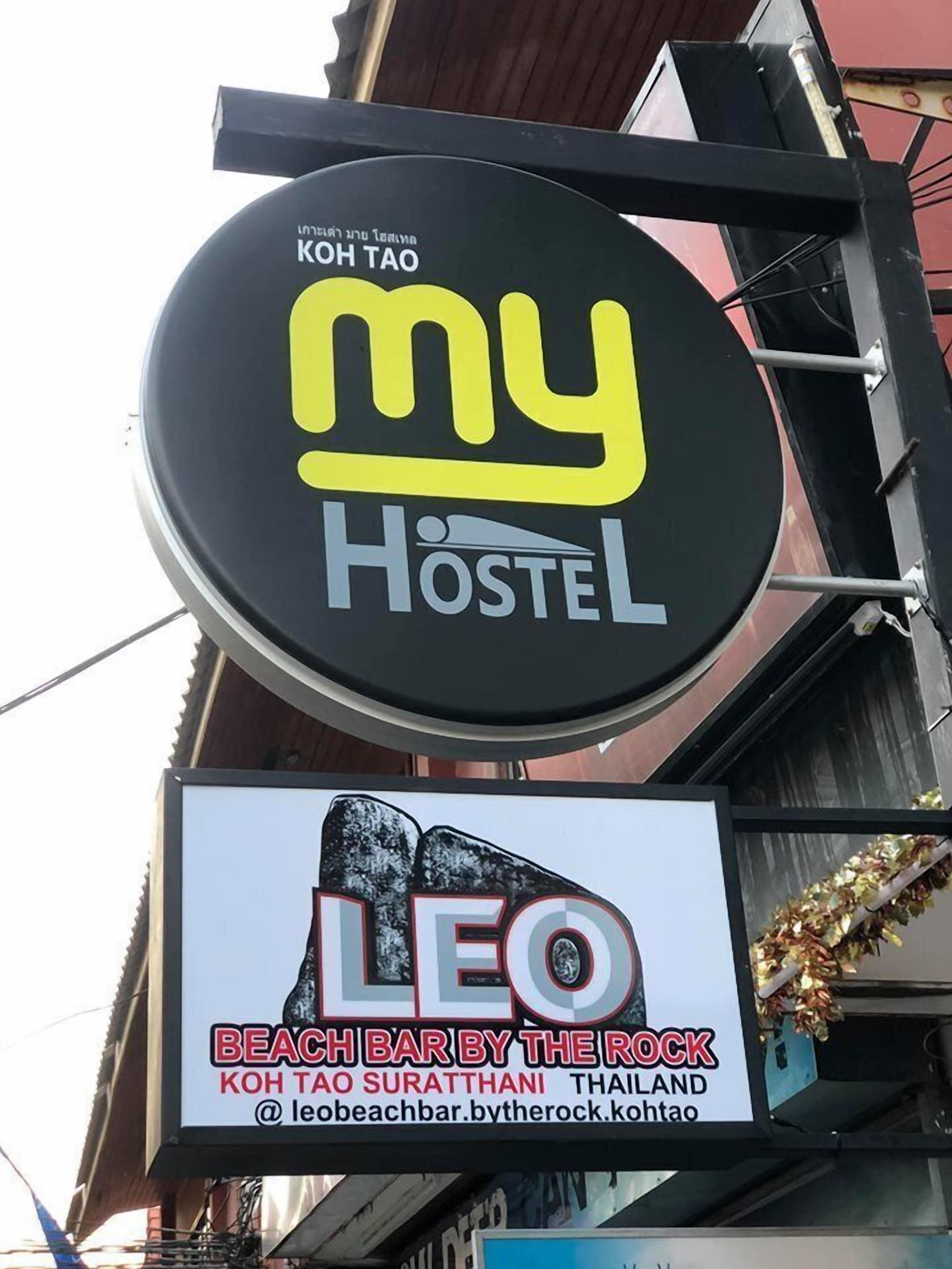 A sign for 'my Hostel Koh Tao' and 'Leo Beach Bar by the Rock'.