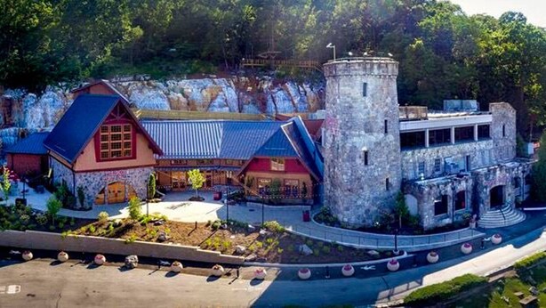 A castle-like building with a tower, surrounded by greenery and a parking area. - ✪ Hidden Valley ✪ FREE Parking, Pool & Gym! (Ooltewah)