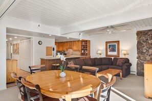 Cozy living area with a dining table, sofa, and kitchenette.