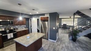 A modern kitchen with granite countertops, stainless steel appliances, and a central island. - Old Town Scottsdale hidden gem! Hot Tub is private! Inquire pricing! (Scottsdale)