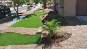 A landscaped area with artificial grass, a small palm tree, and a brick pathway. - Old Town Scottsdale hidden gem! Hot Tub is private! Inquire pricing! (Scottsdale)