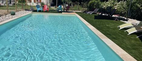 Seasonal outdoor pool, open 10:00 AM to 8:00 PM, pool umbrellas