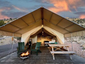 A tented accommodation with a fire pit, green chairs, and a picnic table. - Zion Glamping Tent #6 with AC, Heat & Private Bath (Orderville)