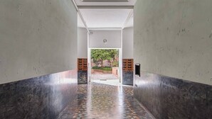 A hallway with a tiled floor, white walls, and a ceiling with recessed lighting. - A. M.P. Vatican House (Roma)