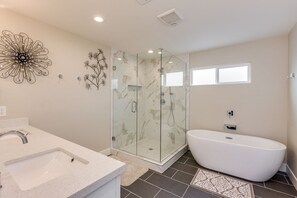 Bathtub, hair dryer, towels, toilet paper