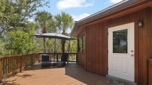 A wooden deck with a white door, two chairs, and an umbrella. - Boaters Paradise W Dock Access - .4 Mile to Beach (Englewood)