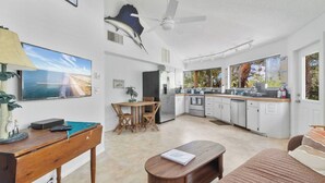 A modern kitchen with white cabinets, a built-in oven, and a large window. - Boaters Paradise W Dock Access - .4 Mile to Beach (Englewood)