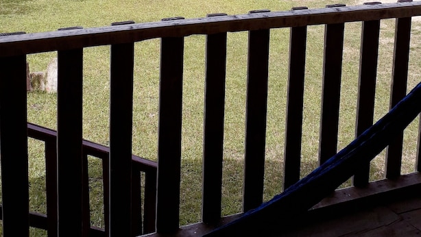 A view of a lake from a wooden deck with a railing. - Cabanas Islas de Tziscao (La Trinitaria)