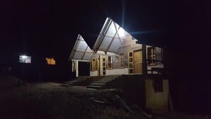 A two-story building with a sloped roof and a staircase leading to the entrance. - Cabanas Islas de Tziscao (La Trinitaria)