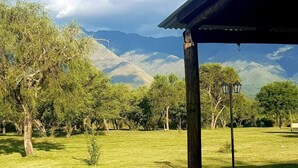 A grassy area with trees and a pavilion. - La Maina Cabañas (San Javier)