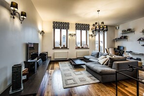 TV, fireplace, books - Orchids Suite. Old Town Roof Terrace Best View Two bedrooms Free Parking  (Kaunas)