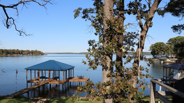 A lakeside property with a wooden dock, a covered seating area, and a gazebo. - Waterfront Home! Relax & Enjoy the Serenity of Lake Palestine.  
 (Chandler)
