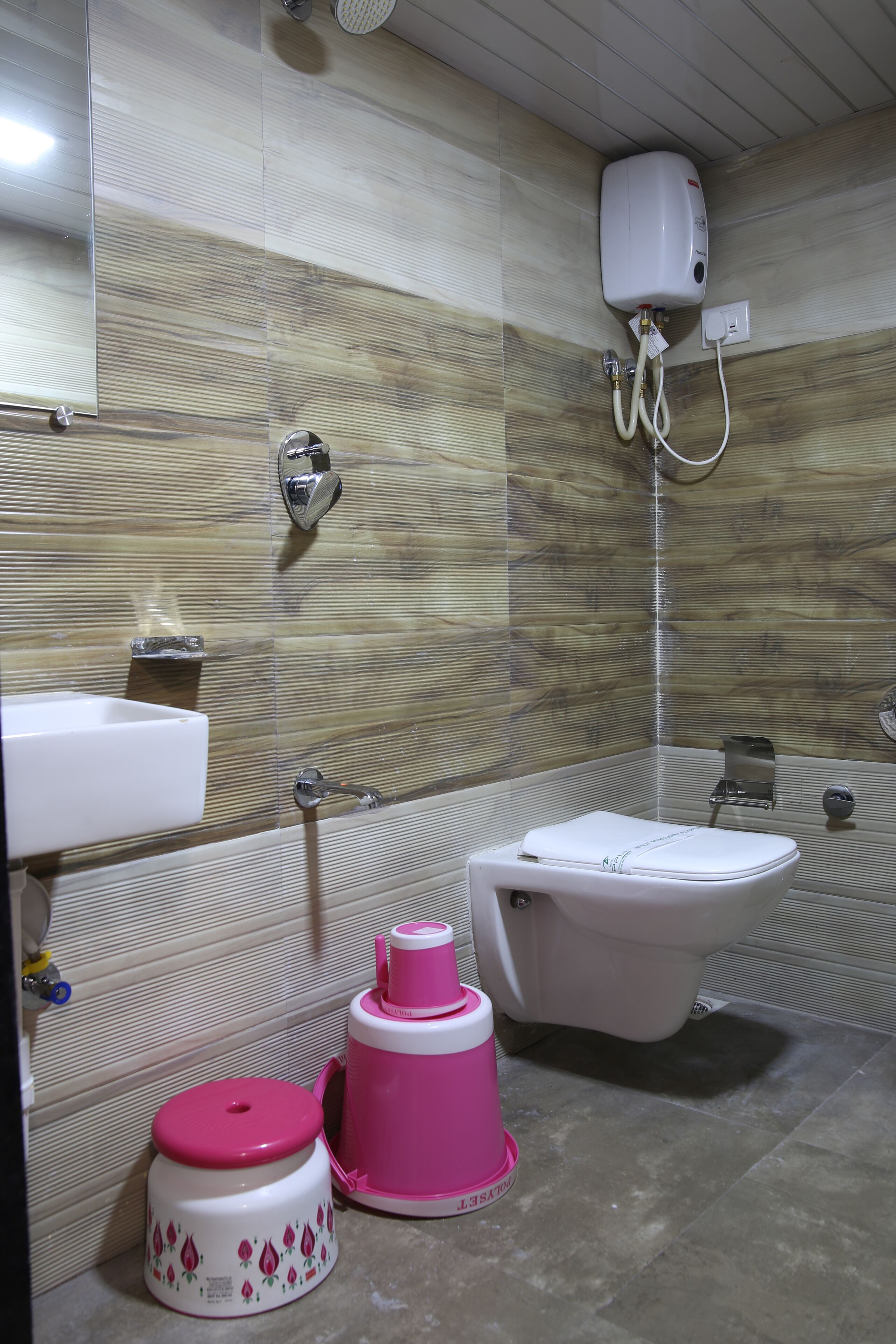 A bathroom with a sink, toilet, and shower.