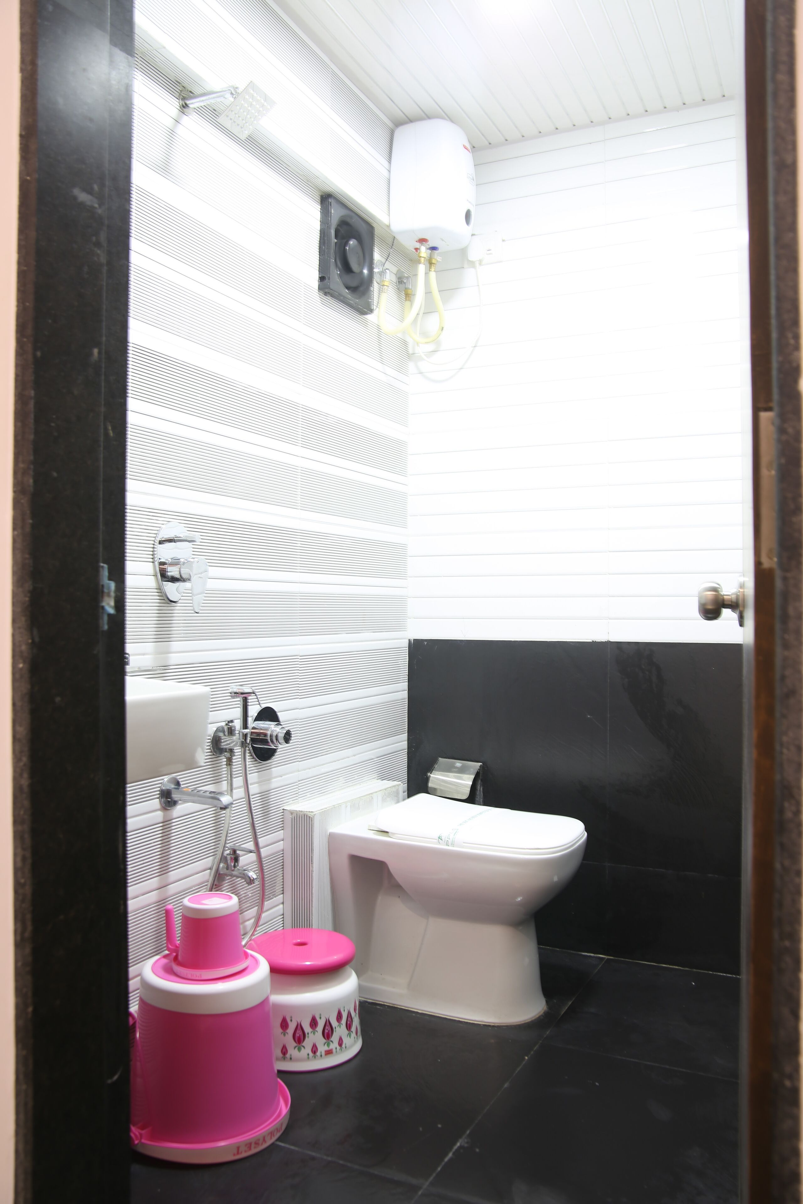 A bathroom with a toilet, a sink, and a shower.