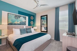 A modern hotel room with a large bed, a ceiling fan, and artwork on the walls. - Lavish Home Near Parks w/ Ice Princess & Space BRs, Theater, Huge Arcade & Pool (Kissimmee)