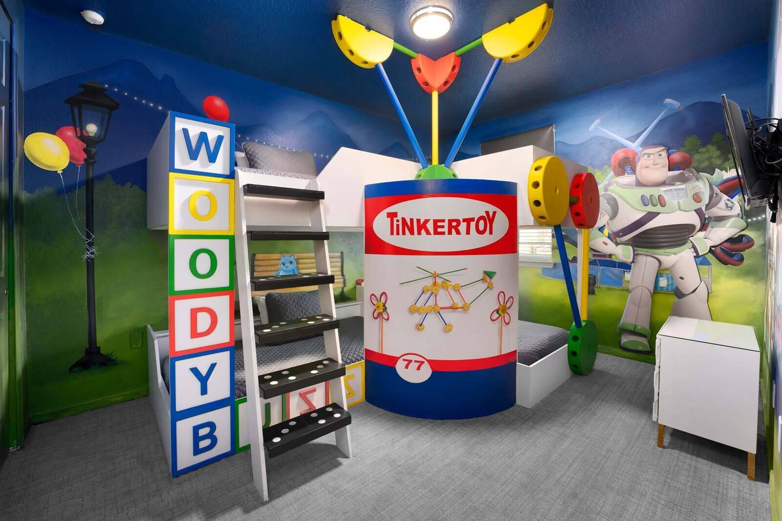 A children's playroom with a toy rocket, a toy figure, and a play structure.