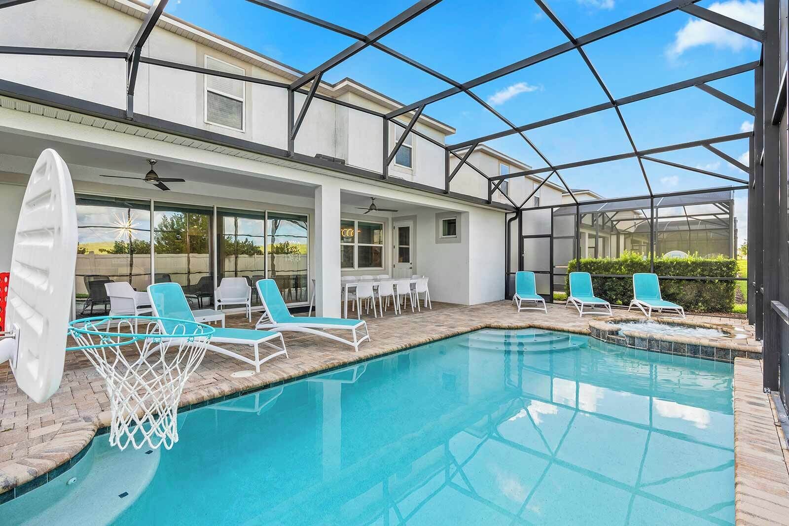 A swimming pool with lounge chairs and a covered patio area.