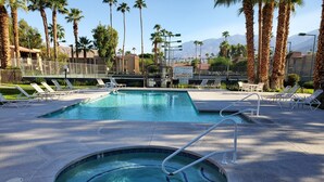 A swimming pool with lounge chairs and a hot tub, surrounded by palm trees and mountains. - PSP Dream Stay -  Large 2 bdm 2 bth condo- pickleball, tennis, all amenities  (Palm Springs)