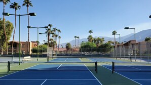 A tennis court with multiple courts, palm trees, and a mountain backdrop. - PSP Dream Stay -  Large 2 bdm 2 bth condo- pickleball, tennis, all amenities  (Palm Springs)