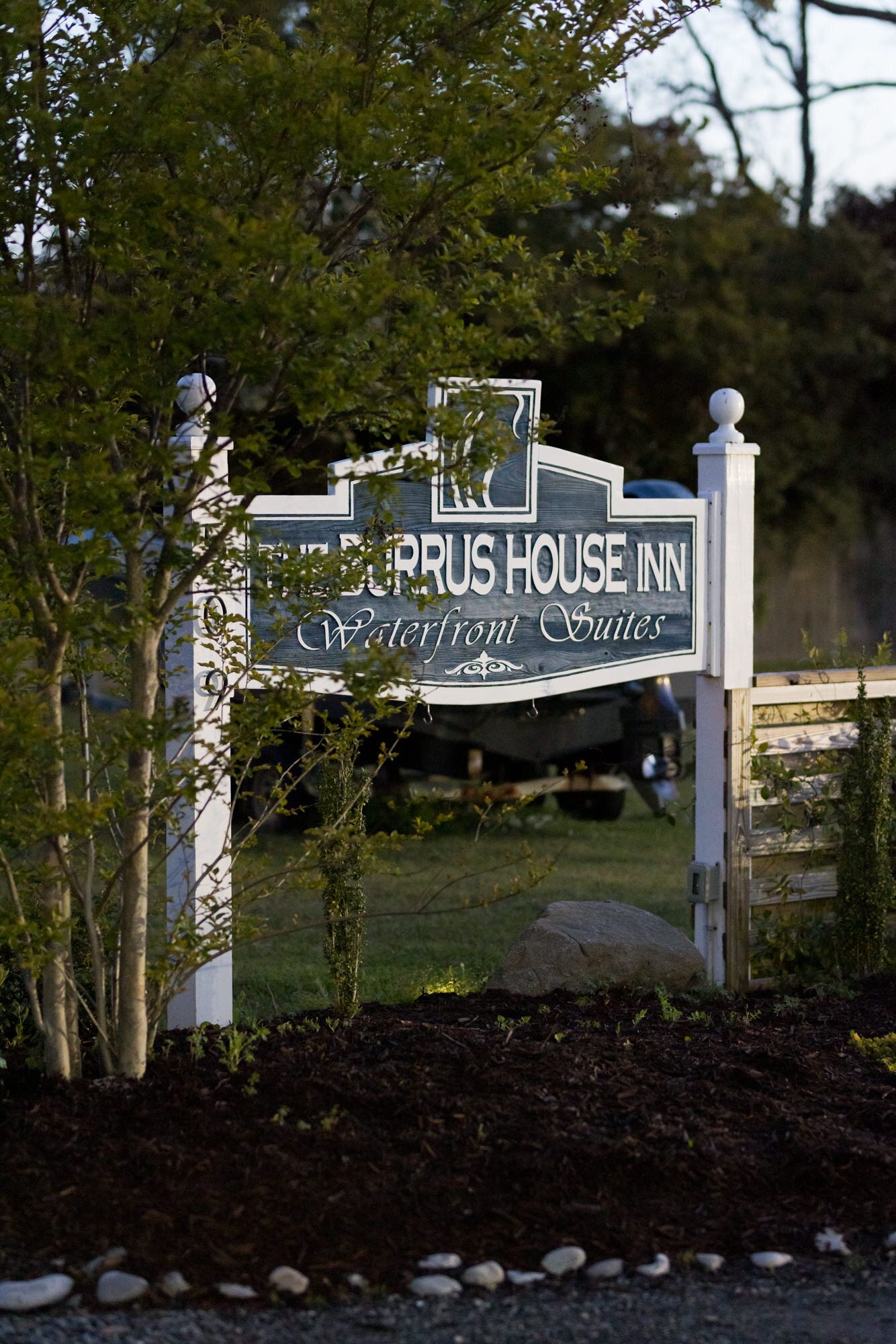 A sign for the ZURUS HOUSE INN Waterfront Suites.
