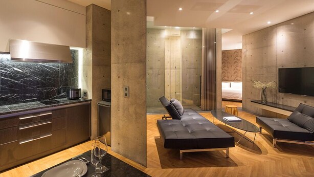 A modern hotel room with a kitchen, a lounge area, and a bedroom. - Memory Maker (Gapyeong)