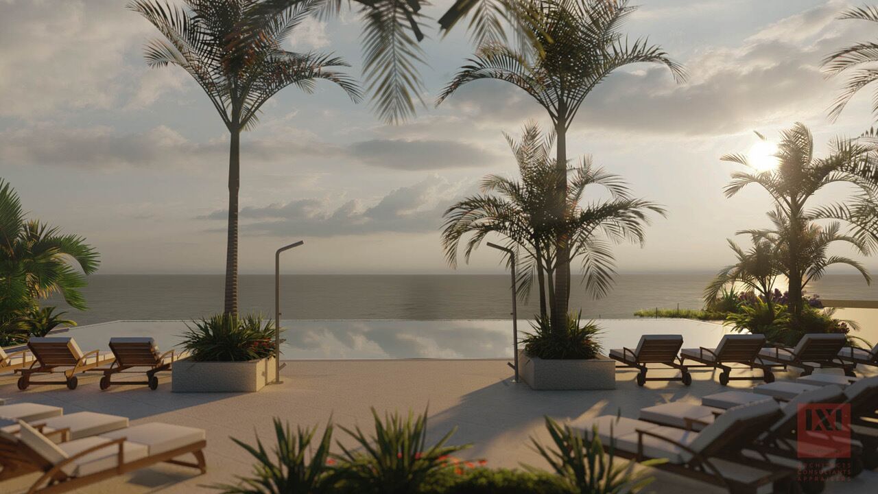 A beachside lounge with sun loungers and palm trees, overlooking the ocean.