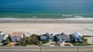 A coastal residential area with houses adjacent to the beach, a clear sky, and a calm sea. - Oceanfront, Blissful Sunrises, Beach Gear, BBQ (St. Augustine)