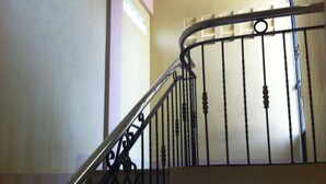 A curved staircase with ornate metal railings and a handrail. - Spurlock Residences (Lapu-Lapu)