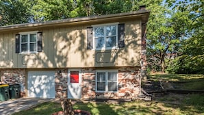 A two-story house with a brick facade and a front door with a red accent. - Comfortable and elegant 3BDR duplex, unit # 3 (Overland Park)