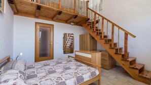 A bedroom with a wooden bed, a wooden wardrobe, a wooden desk, a wooden chair, and a wooden staircase. - 2 bedroom cozy home in Josinovac (Josinovac)